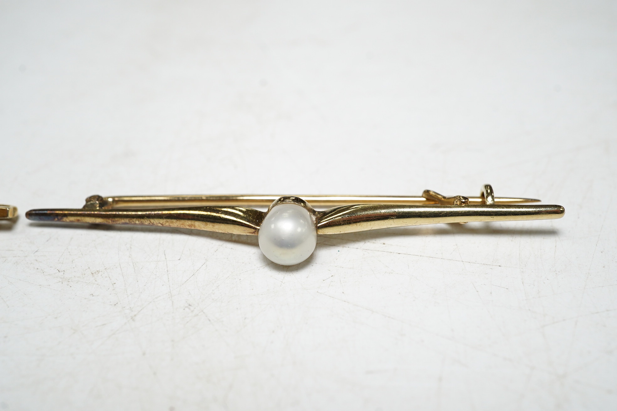 A 9ct gold split pearl and enamel set bar brooch, 1.9 grams, and a cased yellow metal pearl set bar brooch. Condition - good